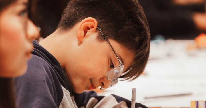 A Puro PREP Plus participant engages in a reflective writing exercise at a peer support gathering.